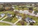 Aerial view of a home near the water, showcasing its landscaped yard, long driveway, and neighborhood at 123 Glasgow Dr, Clayton, NC 27520