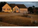 Inviting home at twilight, adorned with holiday lights, highlighting the home's curb appeal at 123 Glasgow Dr, Clayton, NC 27520