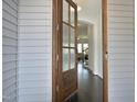 Warm entryway featuring a wood door with textured glass, opening into a home with dark hardwood floors at 130 Scarlet Oak Ln, Chapel Hill, NC 27516