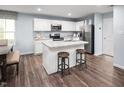 Bright kitchen with white cabinets, stainless steel appliances, and a granite island at 133 Cavalier Rider Run, Wendell, NC 27591
