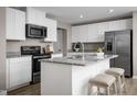 Modern kitchen featuring white cabinets, stainless steel appliances, and granite countertops at 133 Cavalier Rider Run, Wendell, NC 27591