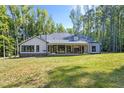 Expansive backyard with a covered patio and outdoor fireplace, perfect for entertaining or relaxing at 140 Winsome Ln, Chapel Hill, NC 27516