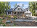 Well-maintained home with stone accents, a charming front porch, and beautiful landscaping at 140 Winsome Ln, Chapel Hill, NC 27516