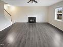 Spacious living room with hardwood floors, a fireplace, and large windows offering natural light at 157 W Copenhaver Dr, Clayton, NC 27527