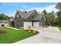 Beautiful home with a three car garage and lush landscaping at 1600 Sweetwater Ln, Raleigh, NC 27610