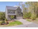 Charming two-story home featuring an attached two-car garage and beautifully landscaped front yard at 1680 Mint River Dr, Apex, NC 27502