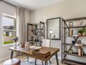 The home office features a large window, a desk, and wooden bookshelves at 2106 Cherry Creek Rd, Haw River, NC 27258