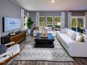 Spacious living room with modern decor, large windows, and ample seating, great for entertaining at 2110 Cherry Creek Rd, Haw River, NC 27258