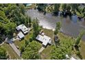 Aerial view of the property showing the home, surrounding trees and waterfront access to the lake at 2118 Timberlake Dr, Raleigh, NC 27604