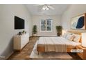 Light and airy bedroom showcasing modern decor, hardwood floors, and a large window for ample natural light at 2356 Bay Harbor Dr, Raleigh, NC 27604
