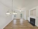 Open-concept living room featuring hardwood floors and modern fireplace, offering a bright and airy feel at 2356 Bay Harbor Dr, Raleigh, NC 27604