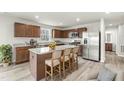 Modern kitchen features stainless steel appliances, an island and wood cabinetry at 265 Day Farm Dr, Lillington, NC 27546