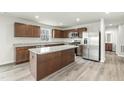 Modern kitchen features stainless steel appliances, an island and wood cabinetry at 265 Day Farm Dr, Lillington, NC 27546
