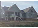 New home featuring a covered back porch with stairs leading to the yard at 2833 Faucette Ln, Burlington, NC 27217