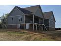New home with a covered back porch, brick foundation and outdoor access doors at 2833 Faucette Ln, Burlington, NC 27217