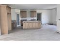 Spacious kitchen featuring an island, ample cabinetry, granite countertops, and hardwood style floors at 2833 Faucette Ln, Burlington, NC 27217