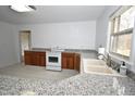 Well lit kitchen with modern appliances and updated cabinets at 300 W Carr St, Mebane, NC 27302