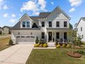 Charming two-story home with a two-car garage, well-manicured lawn, and inviting front porch at 3215 Jones Lake Rd, Fuquay Varina, NC 27526