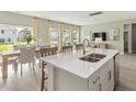 Open-concept kitchen features island with sink, stainless steel appliances, and adjacent dining area at 3401 Rosebush Dr, Zebulon, NC 27597