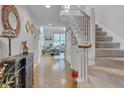 Inviting foyer features hardwood floors, staircase, and a glimpse into the bright living area at 360 Linden Close, Pittsboro, NC 27312