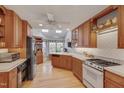 Traditional kitchen with natural wood cabinets, skylights, and modern appliances at 360 Linden Close, Pittsboro, NC 27312
