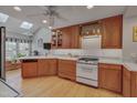 Bright kitchen boasts wood cabinets, white countertops, and plenty of natural light at 360 Linden Close, Pittsboro, NC 27312