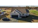 An aerial view of a cozy home featuring a black garage door and a cozy front porch with white railing at 3694 Nc-62 N Hwy, Burlington, NC 27217