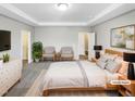 Spacious primary bedroom featuring tray ceilings, ensuite bathroom, and ample closet space at 480 Stonewall Dr, Mebane, NC 27302