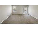 Bright, airy empty room with neutral walls, carpeted floors, and lots of natural light at 480 Stonewall Dr, Mebane, NC 27302