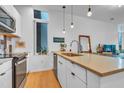 Bright kitchen featuring stainless steel appliances, modern countertop and pendant lighting above the island sink at 521 N Mangum St # 12, Durham, NC 27701