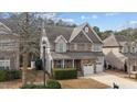 Charming two-story home with stone accents, attached two-car garage, and well-maintained landscaping at 5213 Orabelle Ct, Raleigh, NC 27606
