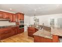 Spacious kitchen boasts granite countertops, stainless steel appliances, and ample cabinet space at 604 S Chavis St, Franklinton, NC 27525