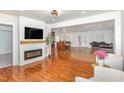 Open concept living room featuring modern fireplace and mantle and a view of the kitchen and dining area at 604 S Chavis St, Franklinton, NC 27525