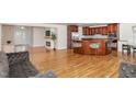 Expansive open-concept living room with hardwood floors and a modern kitchen, perfect for entertaining at 604 S Chavis St, Franklinton, NC 27525