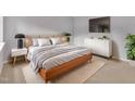 Bright main bedroom featuring sleek furniture, soft decor, and a minimalist design at 612 Pine Ridge Pl, Raleigh, NC 27609