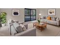 Living room with neutral tones, stylish furniture, a balcony and bright, natural light at 612 Pine Ridge Pl, Raleigh, NC 27609