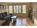 Bright and spacious living room with large windows and hardwood floors at 704 Martin Luther King Jr Blvd # D12, Chapel Hill, NC 27514