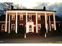Elegant brick home with illuminated columns, enhancing its nighttime curb appeal at 712 Tarleton Ave, Burlington, NC 27215