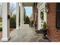 Inviting front porch with stone flooring, rocking chair, and classic decor at 712 Tarleton Ave, Burlington, NC 27215