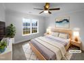 This bedroom offers a ceiling fan and a beautiful window view at 75 Mitchell Store Rd, Youngsville, NC 27596