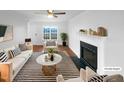 Bright living room featuring a fireplace, comfortable seating, and lots of natural light at 75 Mitchell Store Rd, Youngsville, NC 27596