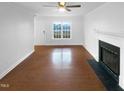 A bright, spacious living room with hardwood floors, a fireplace, and plenty of natural light at 75 Mitchell Store Rd, Youngsville, NC 27596