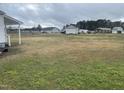 Large backyard, view of surrounding houses and greenery at 804 S Sampson Ave, Dunn, NC 28334