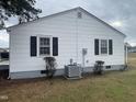 Exterior side view of a white house with black shutters and an AC unit at 804 S Sampson Ave, Dunn, NC 28334