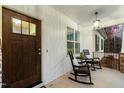 Inviting front porch featuring a rocking chair and pendant lighting at 100 Lexington Ave, Zebulon, NC 27597