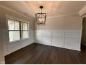 Well-lit dining room featuring wainscoting and wood floors at 100 Spumante Ct, Princeton, NC 27569