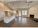Gourmet kitchen with granite countertops, stainless steel appliances, a center island, and an adjoining fireplace at 100 Spumante Ct, Princeton, NC 27569