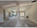 Bright living room flows into the open kitchen featuring an island and a fireplace at 100 Spumante Ct, Princeton, NC 27569