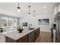 Open kitchen showcasing an island, stainless appliances, and seamless flow into the living area at 1004 Westerland Way # 197, Durham, NC 27703