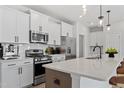Contemporary kitchen boasts white cabinetry, stainless steel appliances, and a spacious countertop at 1004 Westerland Way # 197, Durham, NC 27703